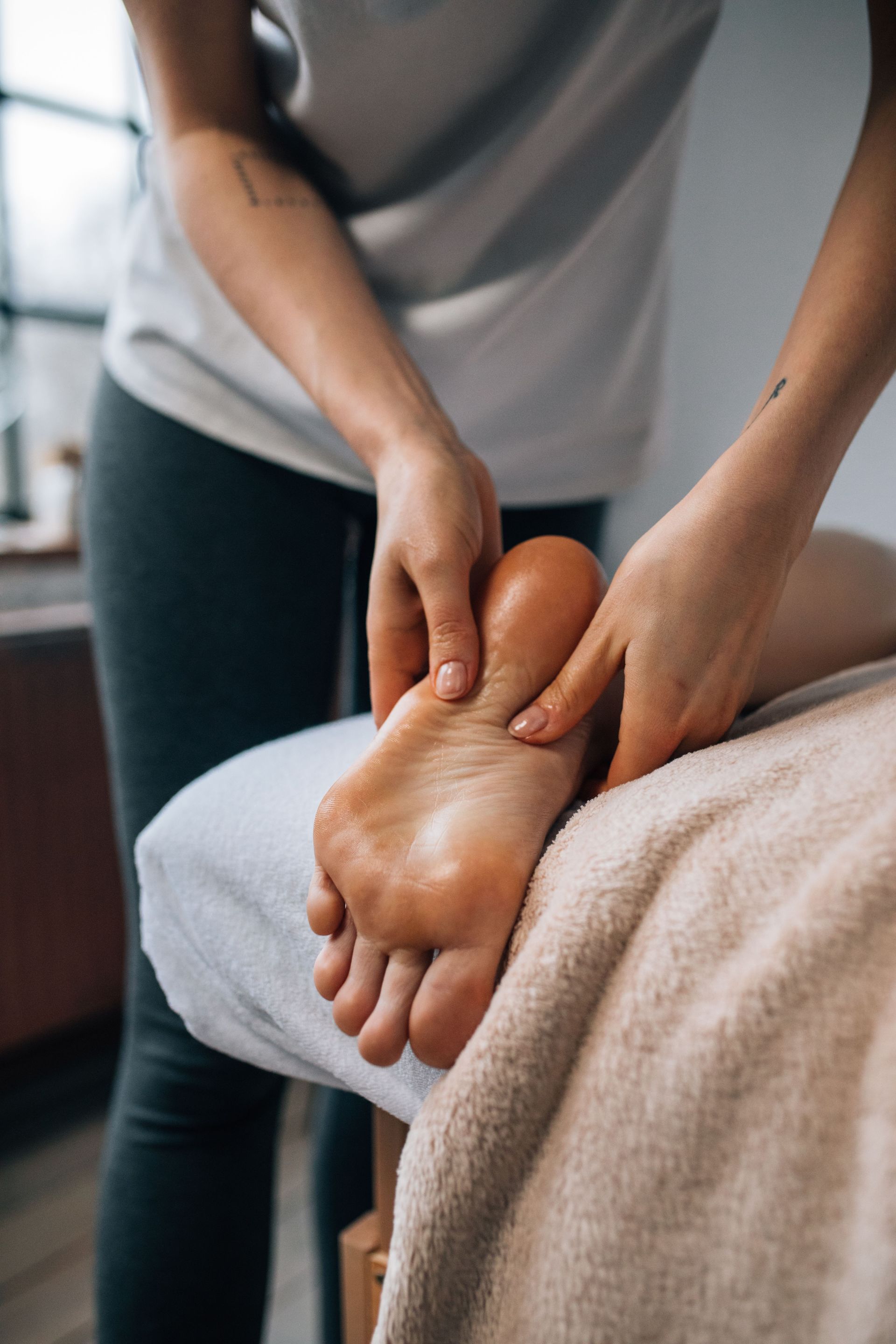 Experience ultimate relaxation with a soothing foot massage in a calming indoor environment.